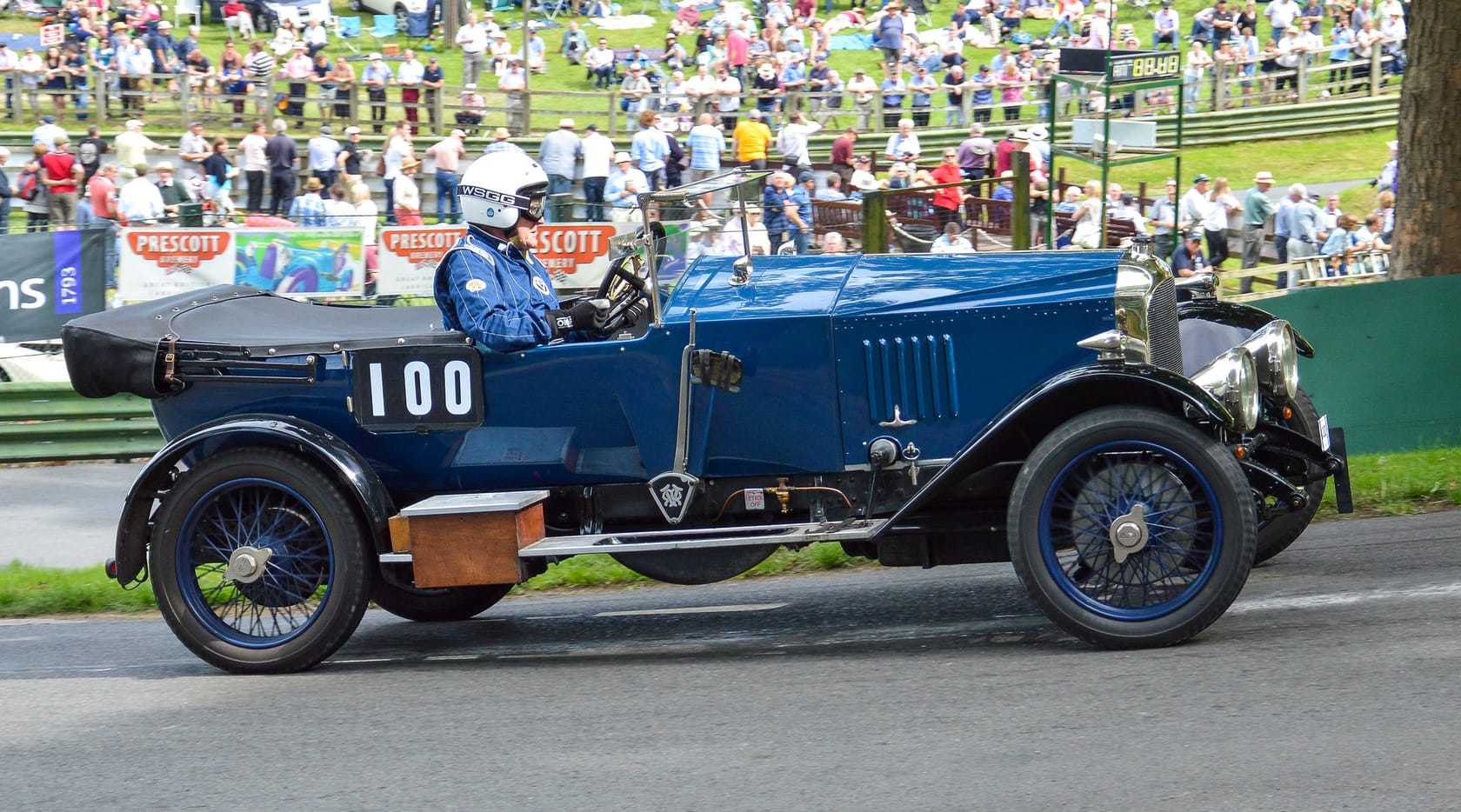 A dark blue 1921 Vauxhall 30-98 E-Type Velox competing at the Prescott hillclimb, carrying the number 100