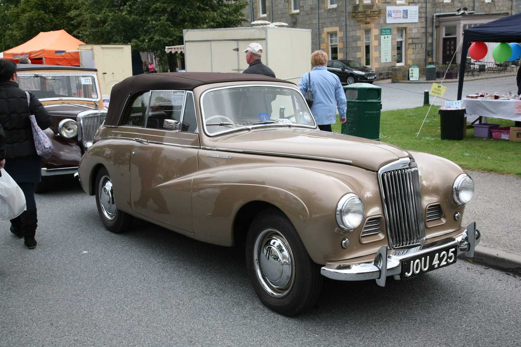 A two-tone brown 1951 Sunbeam-Talbot 90 drophead at a street gathering, front three-quarter view, UK registration JOU 425