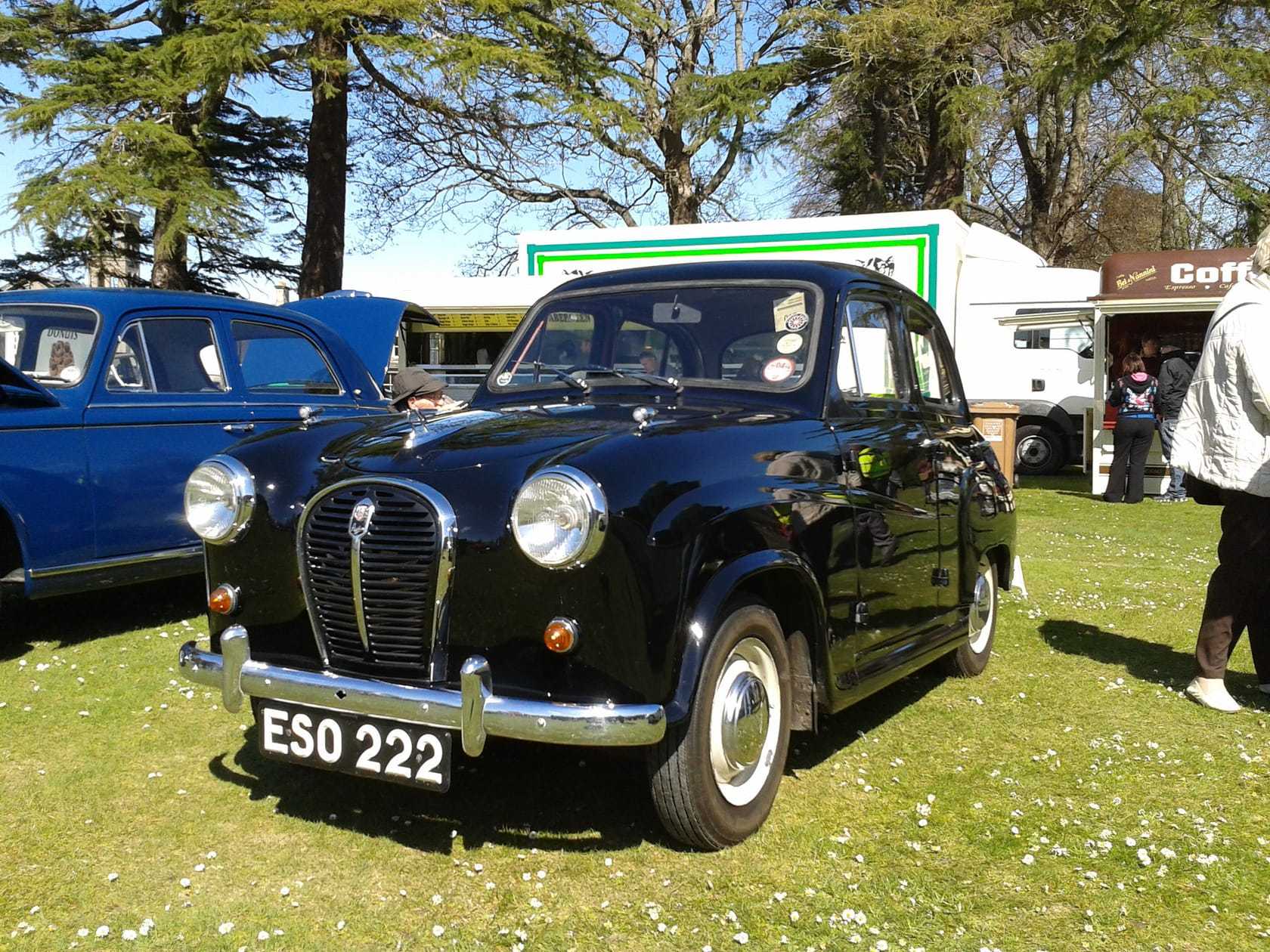 A black 1958 Austin A35 at a classic car show, front three-quarter view, UK registration ESO 222