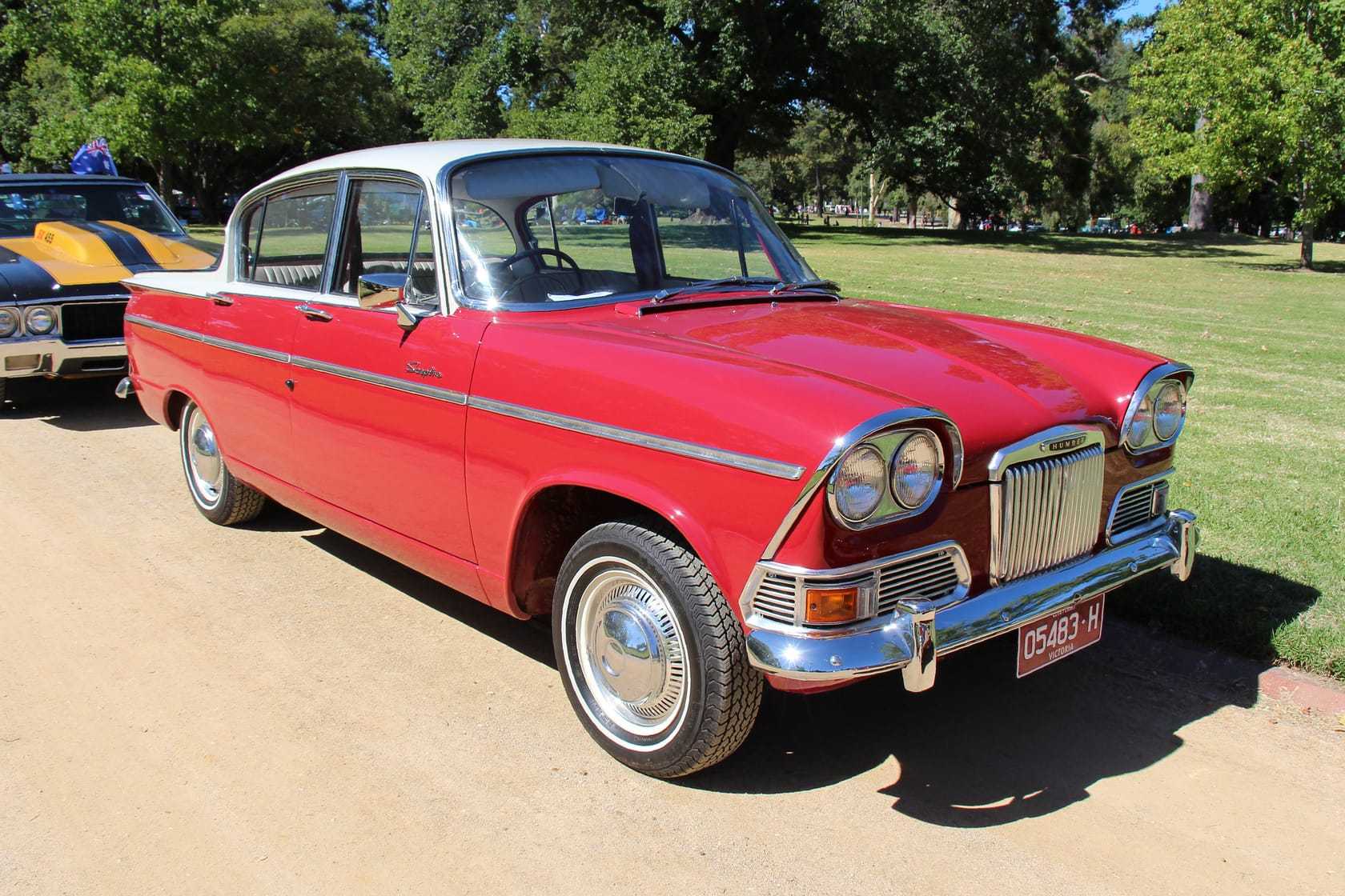 A red Humber Sceptre Mk I saloon on grass in sunshine, front three-quarter view