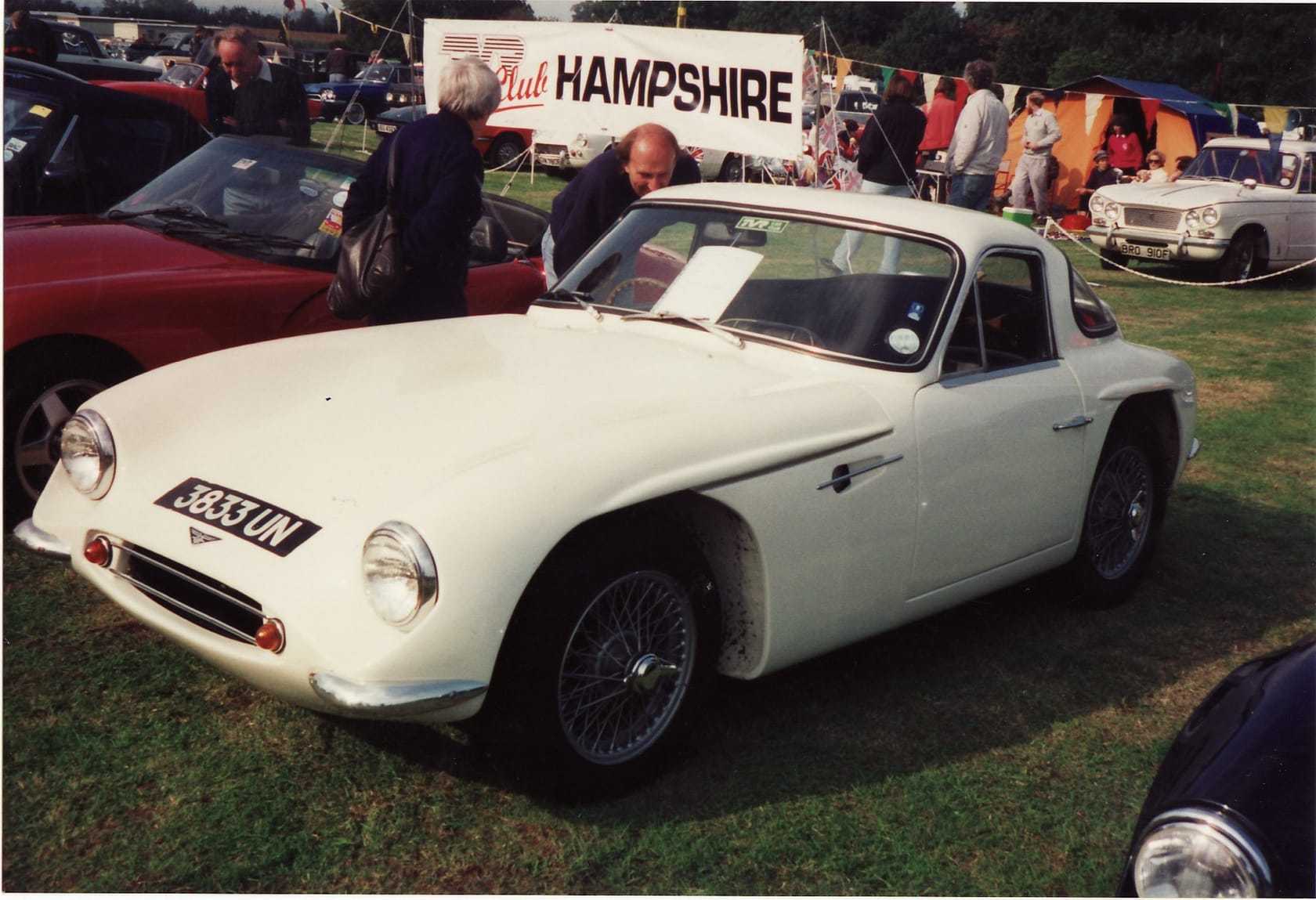 A cream 1962 TVR Grantura with UK registration 3833 UN, front three-quarter view at a classic car show