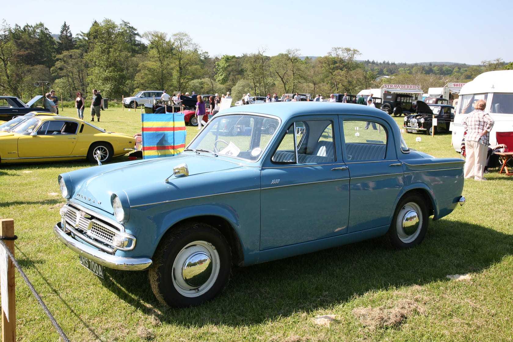A light blue Hillman Minx 1600 saloon on a showground, front three-quarter view