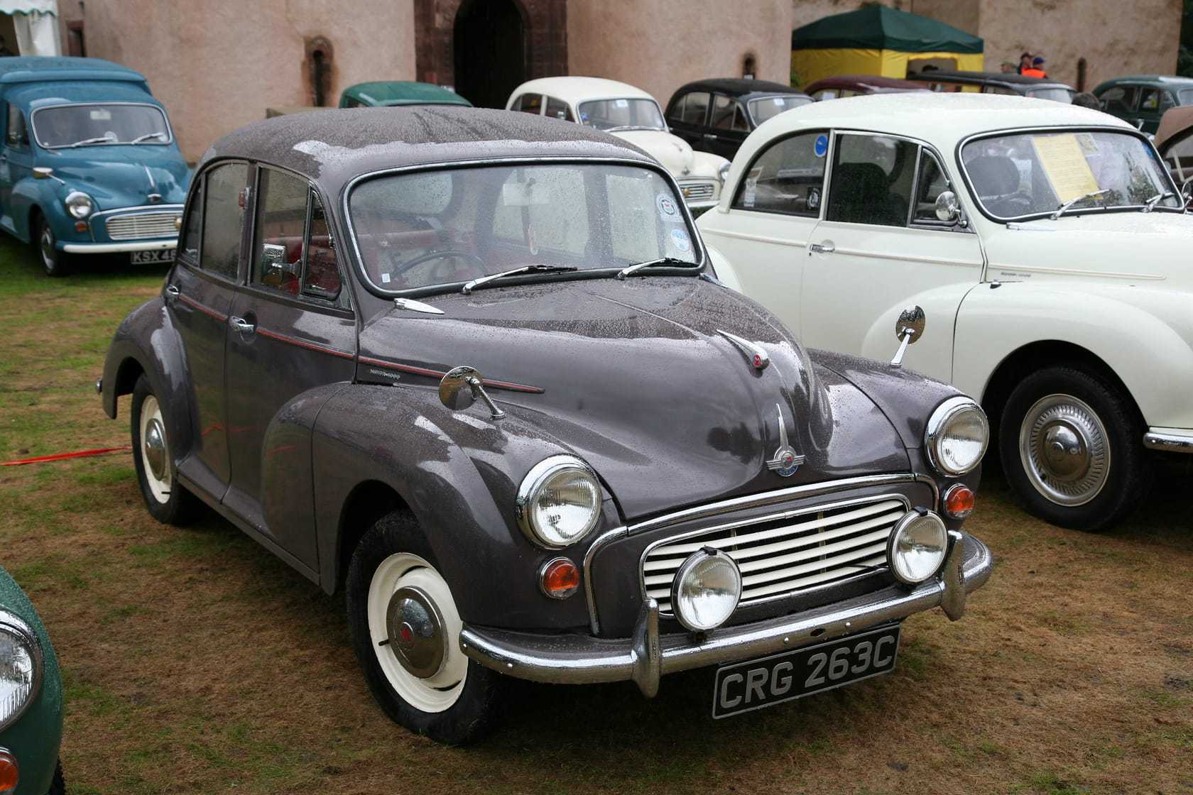 A grey 1965 Morris Minor 1000 saloon at a classic vehicle rally, front three-quarter view, UK registration CRG 263C