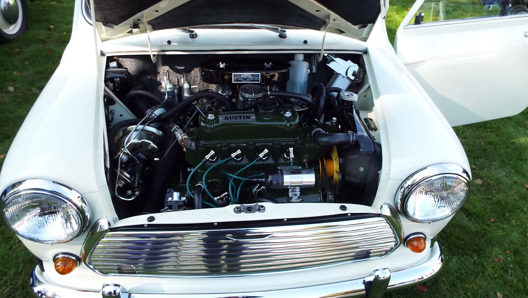 The engine bay of a classic Austin Mini, the BMC A-series four-cylinder engine mounted sideways across the car with the radiator on the left