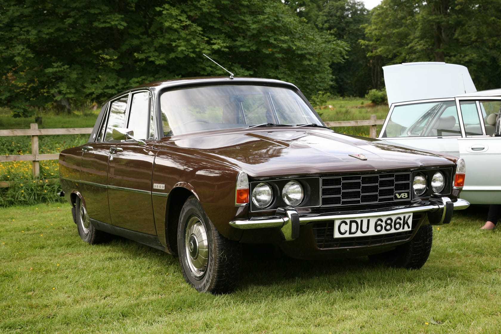 A dark brown 1972 Rover P6 3500 V8 at a classic car show, front three-quarter view, UK registration CDU 686K