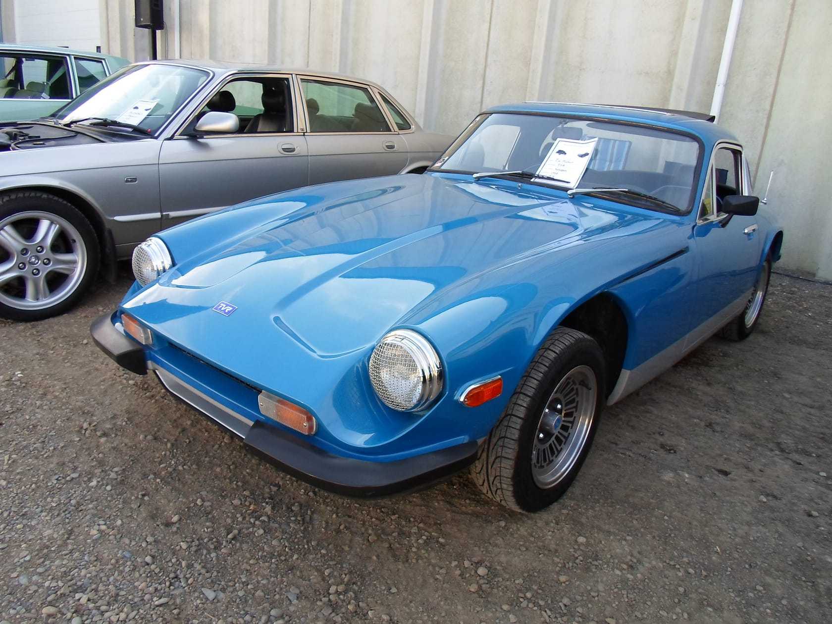 A blue 1978 TVR 3000M displayed in a museum, front three-quarter view