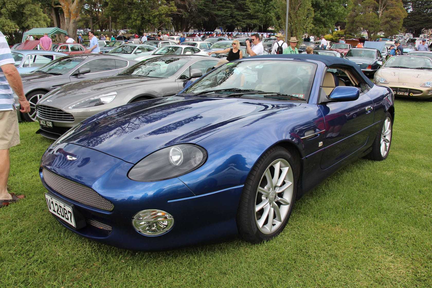 A blue 2003 Aston Martin DB7 Vantage Volante on a show field