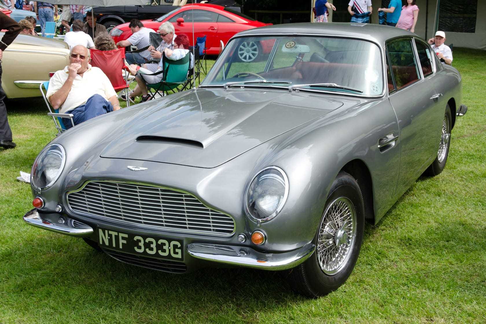 A silver 1968 Aston Martin DB6 with UK registration NTF 333G, front three-quarter view at a show
