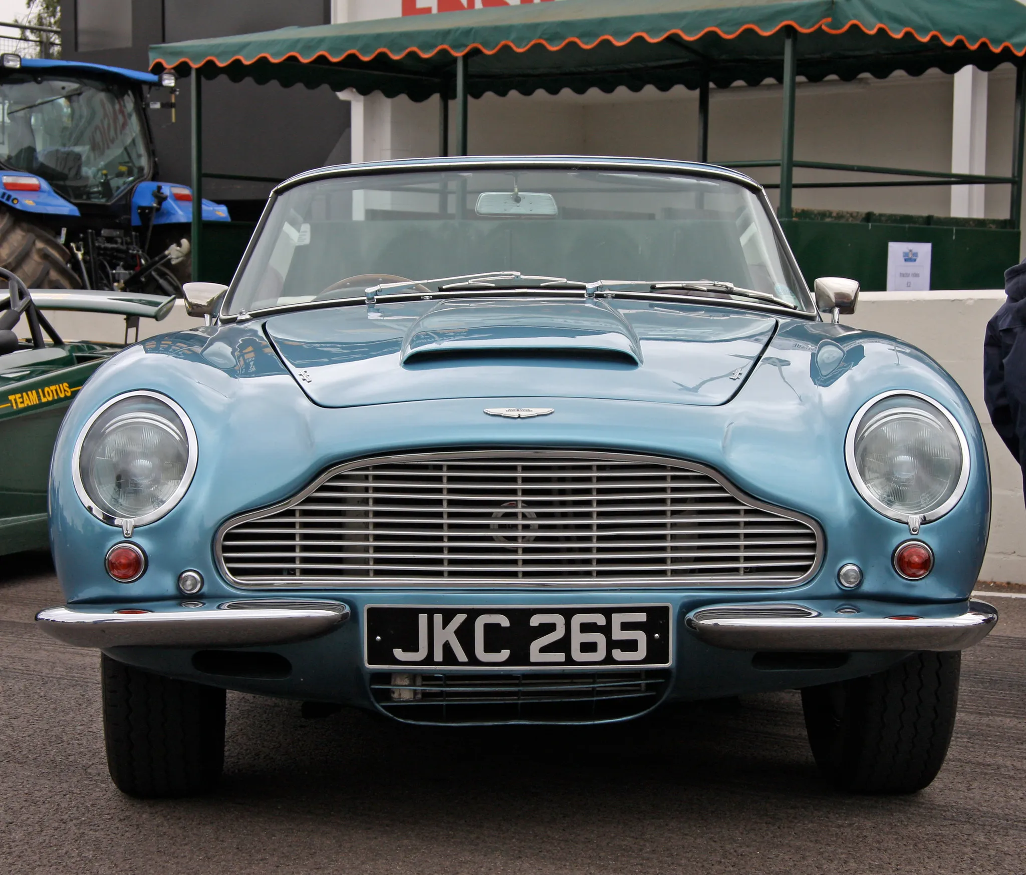 A light blue Aston Martin DB6 Volante convertible seen head-on, UK registration JKC 265