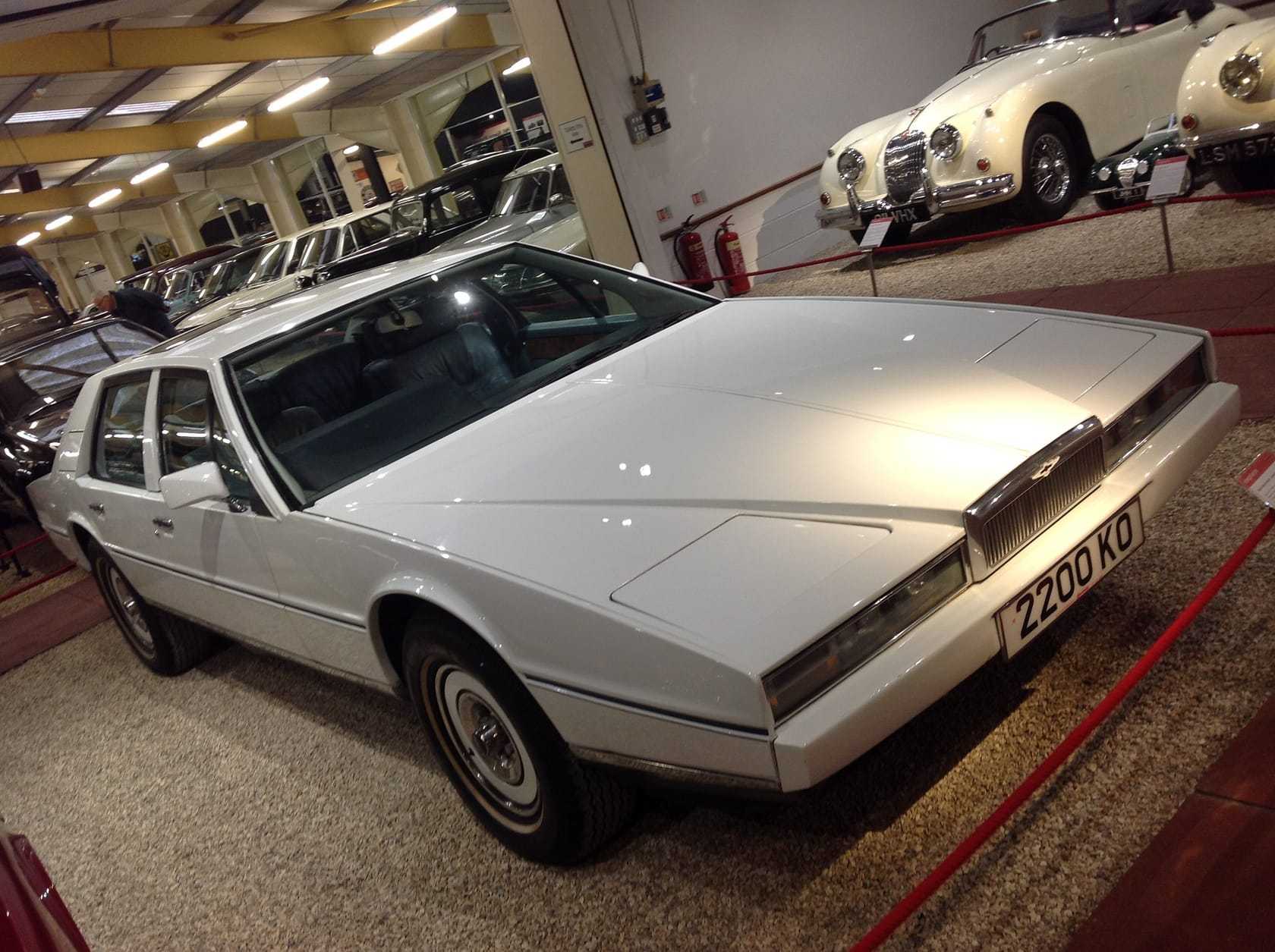 A white 1982 Aston Martin Lagonda wedge in a motor museum