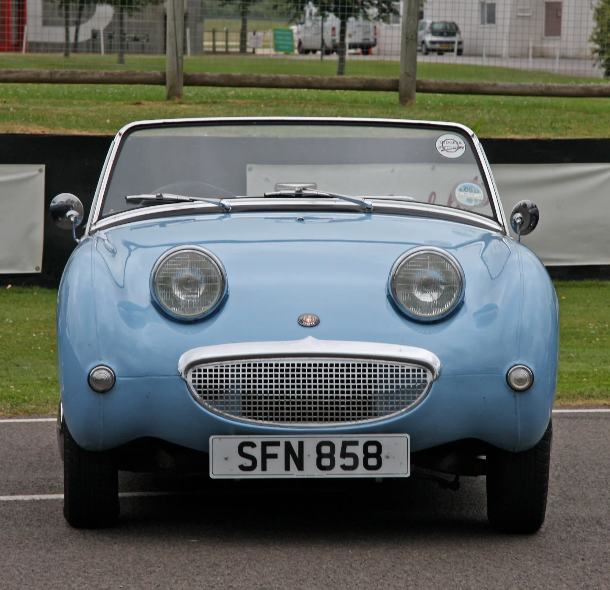 A light blue Austin-Healey Frogeye Sprite, front three-quarter view, with a UK number plate