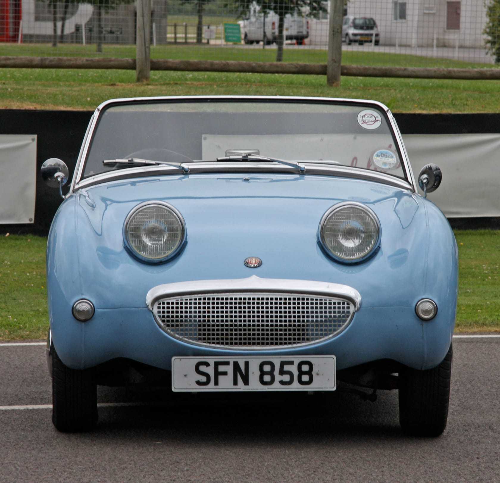 A light blue Austin-Healey Frogeye Sprite, front three-quarter view, with a UK number plate