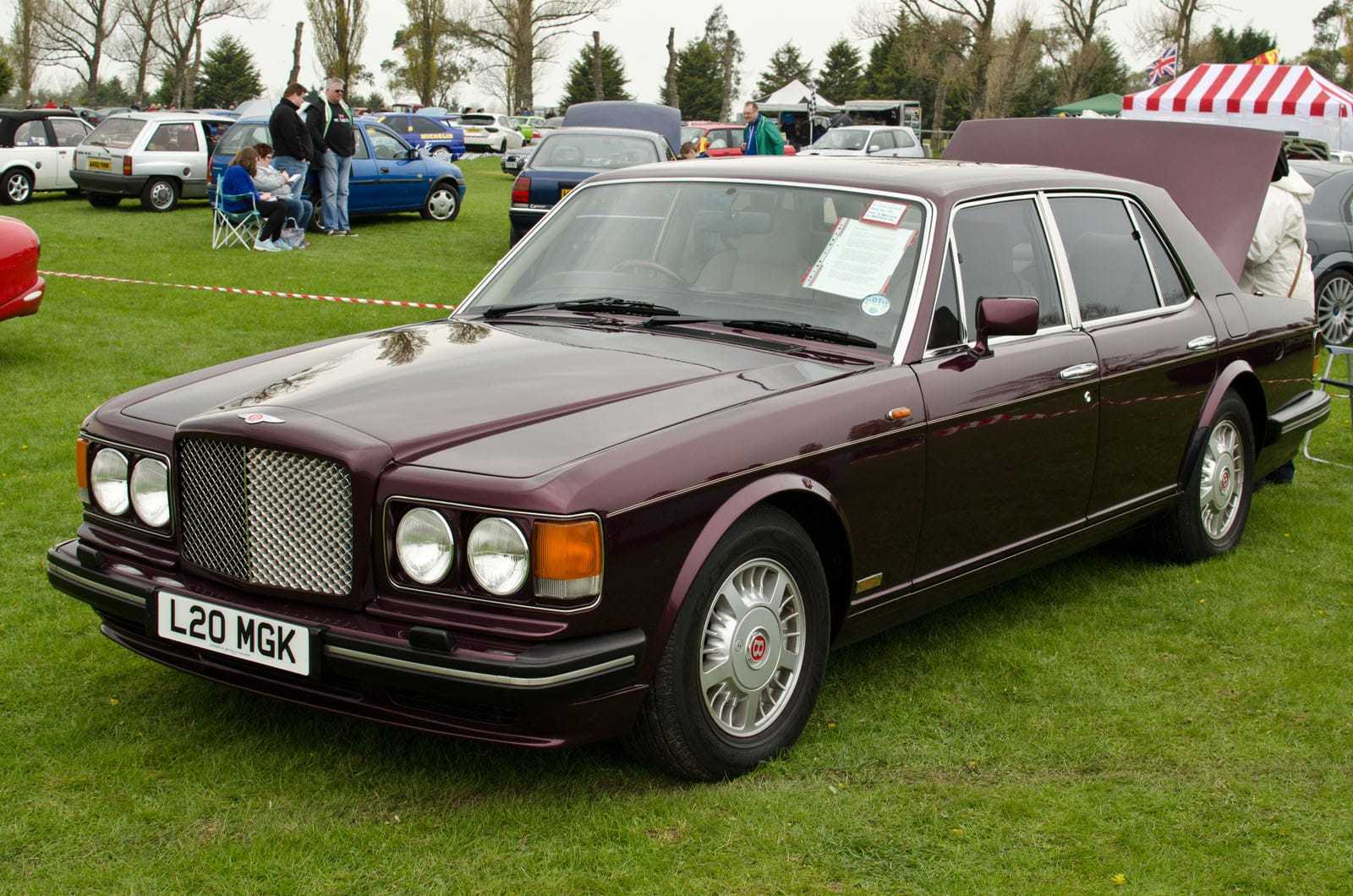 A maroon 1994 Bentley Turbo R with UK registration L20 MGK on a show field