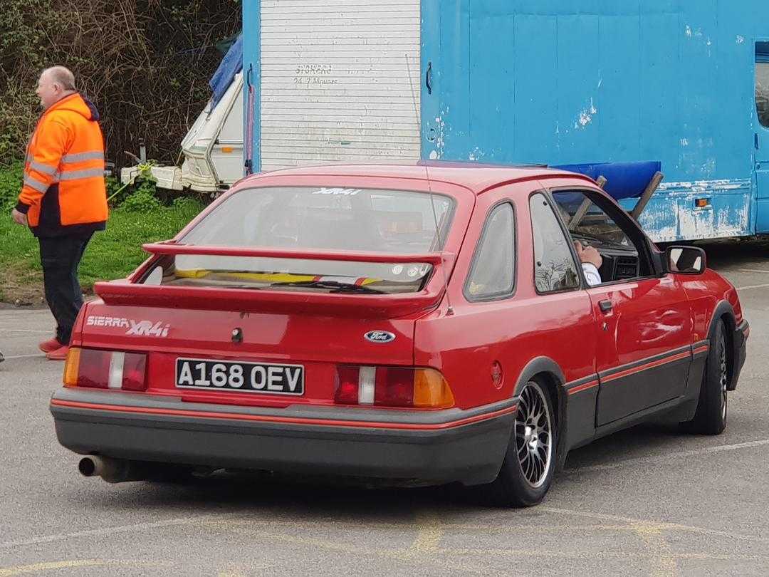 A red 1984 Ford Sierra XR4i showing its double rear spoiler, rear three-quarter view, UK registration A168 OEV