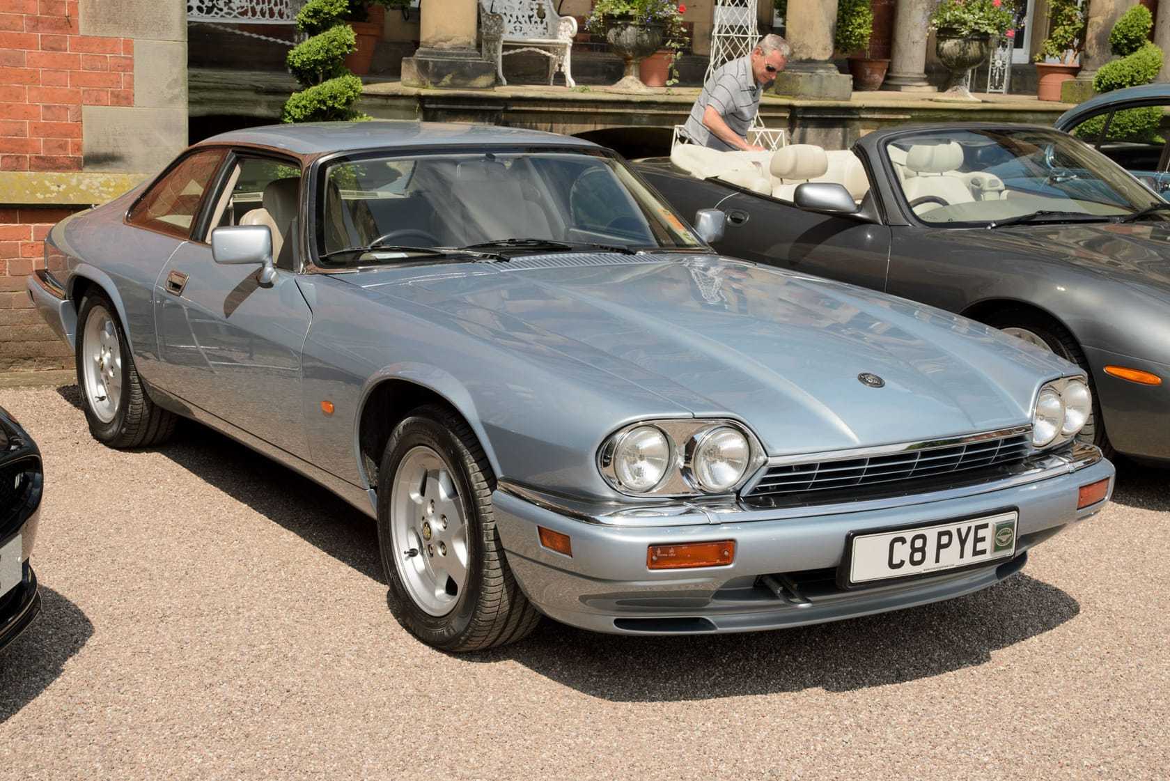 A silver-blue 1995 Jaguar XJS 4.0 coupé with a UK registration parked at a show, front three-quarter view