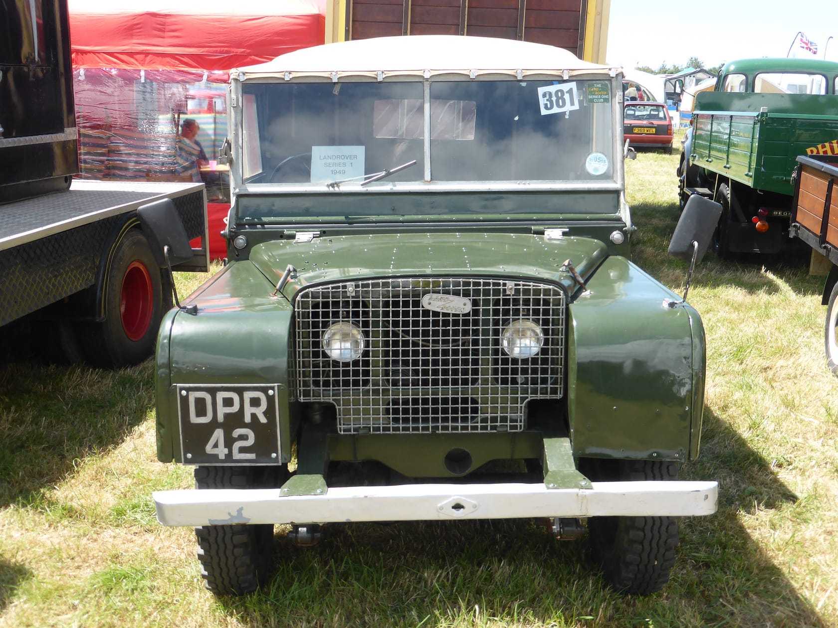 A dark green 1949 Land Rover Series I 80-inch with a UK registration on a show field