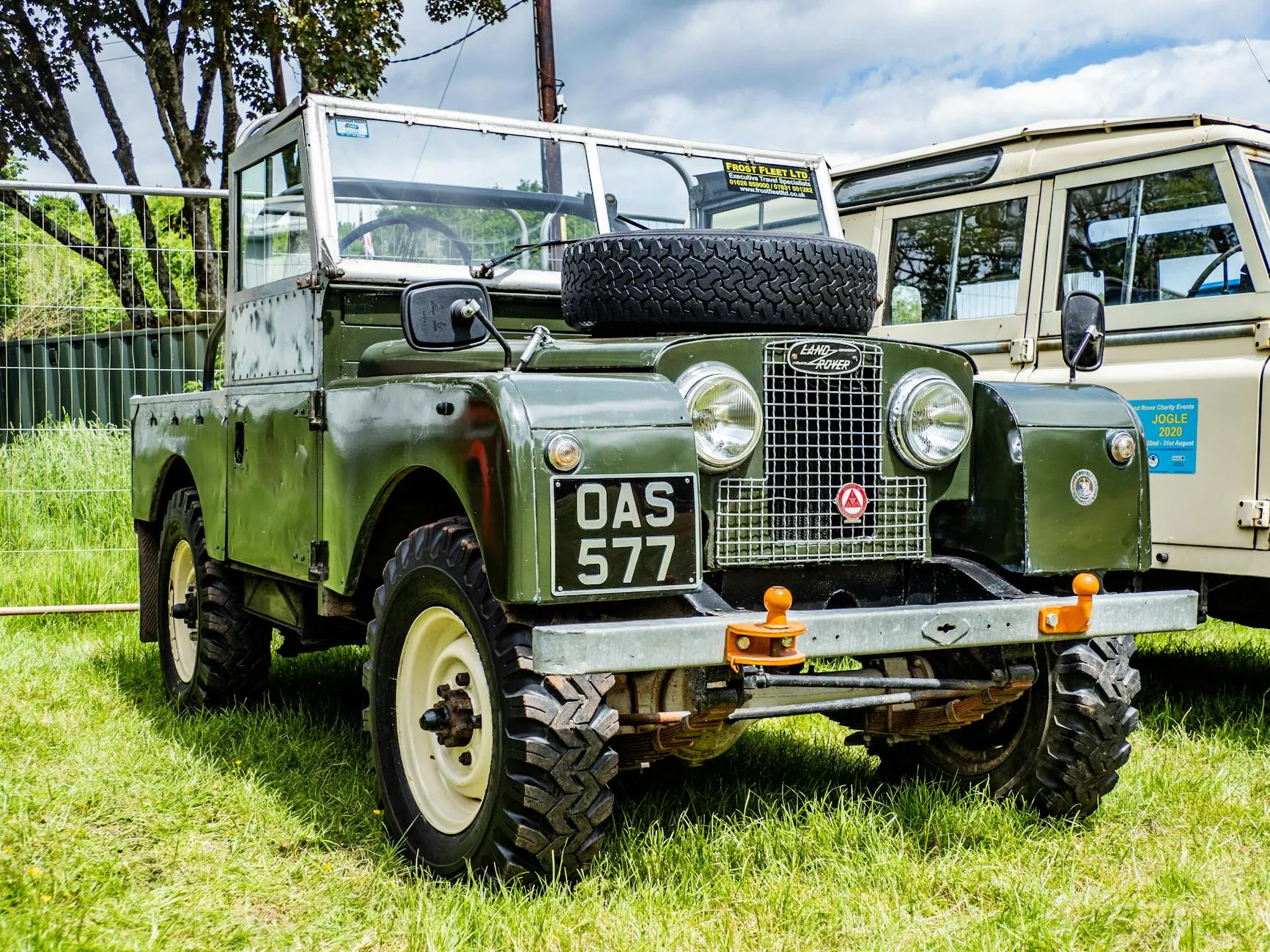 A blue Land Rover Series I at a classic vehicle show