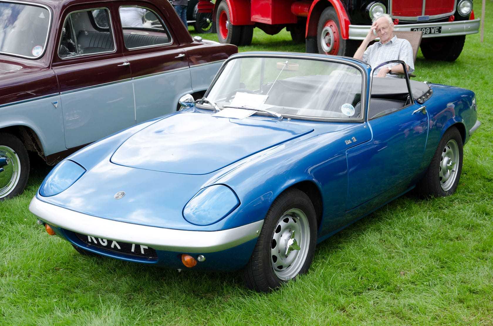 A blue 1967 Lotus Elan S3 SE drophead with a UK registration on a show field