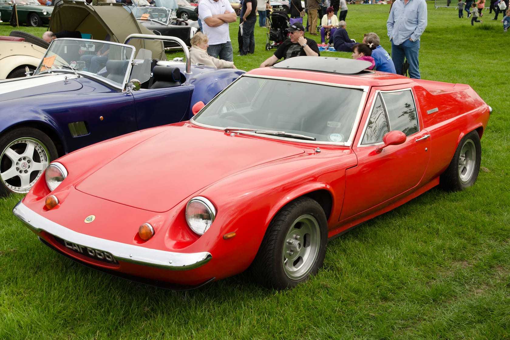 A red 1972 Lotus Europa Twin Cam, front three-quarter view at a classic car show