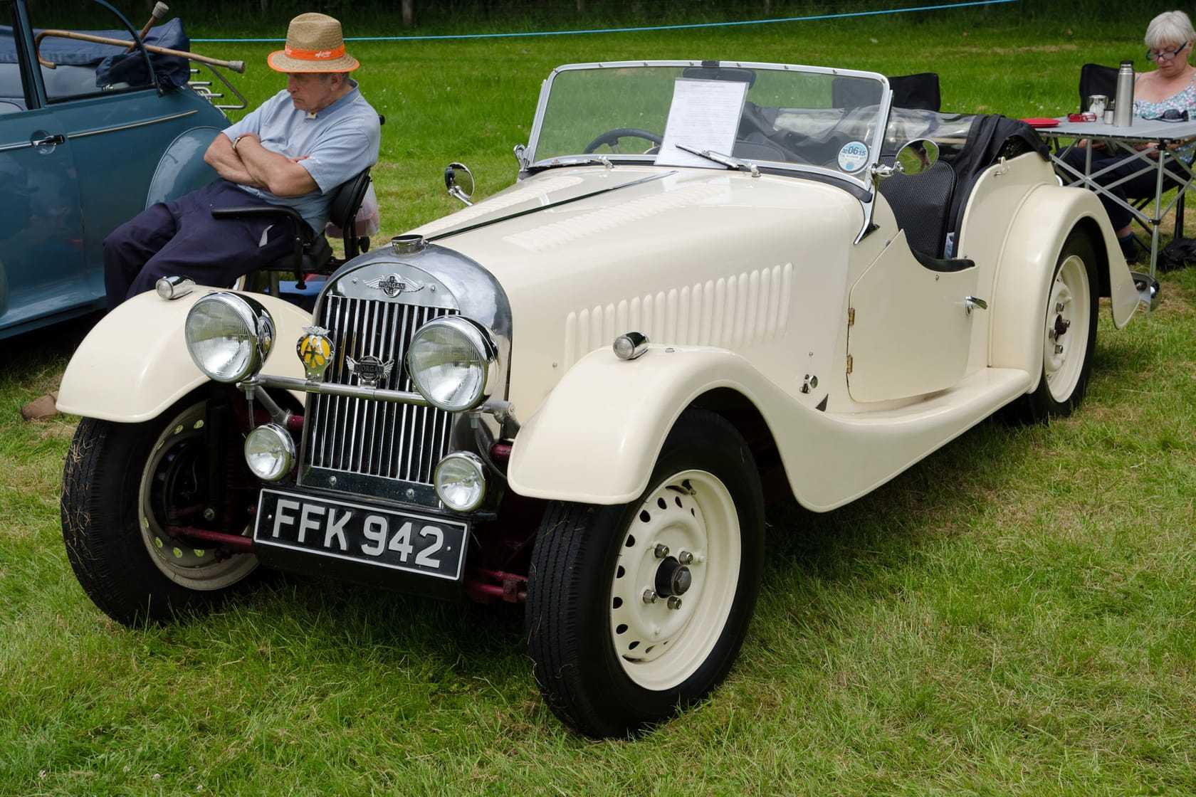 A cream 1952 Morgan Plus 4 with UK registration FFK 942, flat-radiator front, at an outdoor classic car show