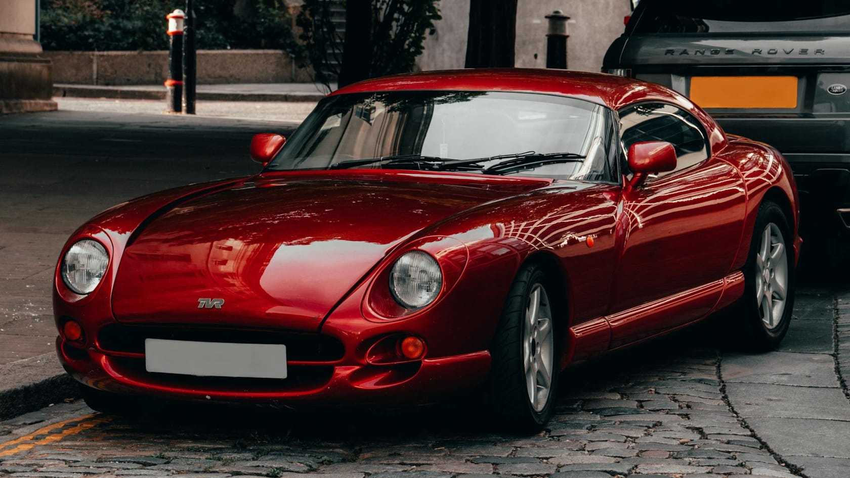 A red TVR Cerbera parked on a cobbled street, front three-quarter view