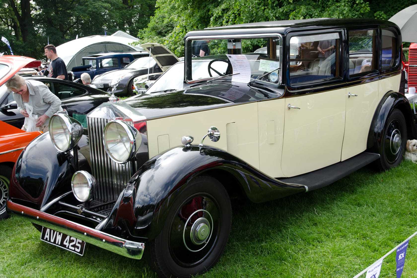 A black and cream 1934 Rolls-Royce 20/25 with UK registration AVW 425 at a classic car show