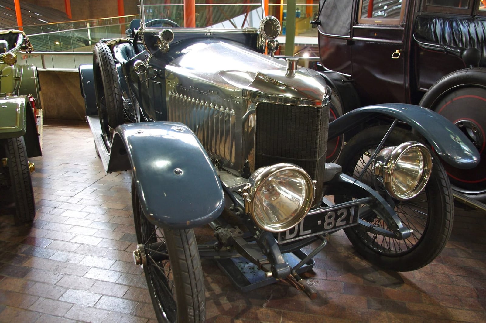 The brass radiator and headlamps of a 1914 Vauxhall Prince Henry in a museum, UK registration DL 821