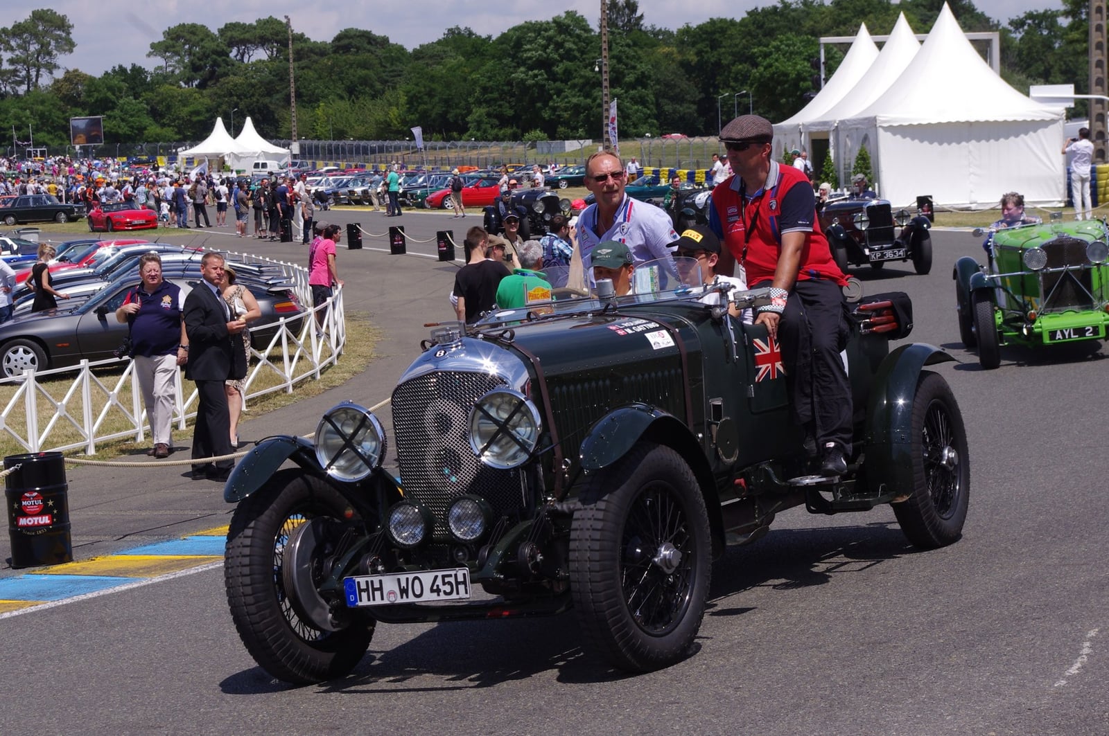 A green Bentley 4.5 Litre tourer of 1928 at a show, front three-quarter view