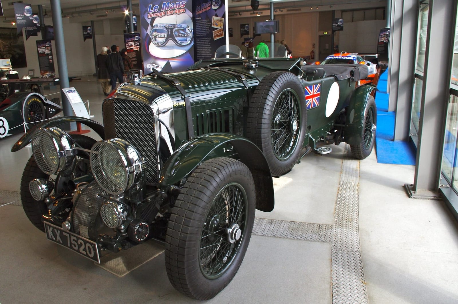 A dark green 1931 4½ Litre Blower Bentley with supercharger visible ahead of the radiator