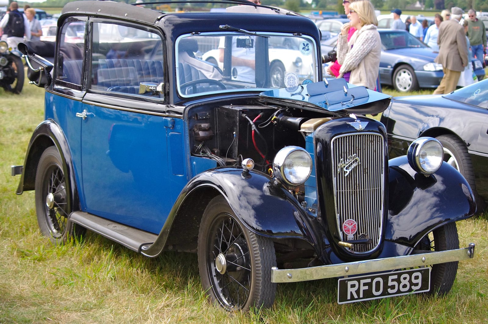 A blue Austin Seven saloon of 1934 on grass, front three-quarter view