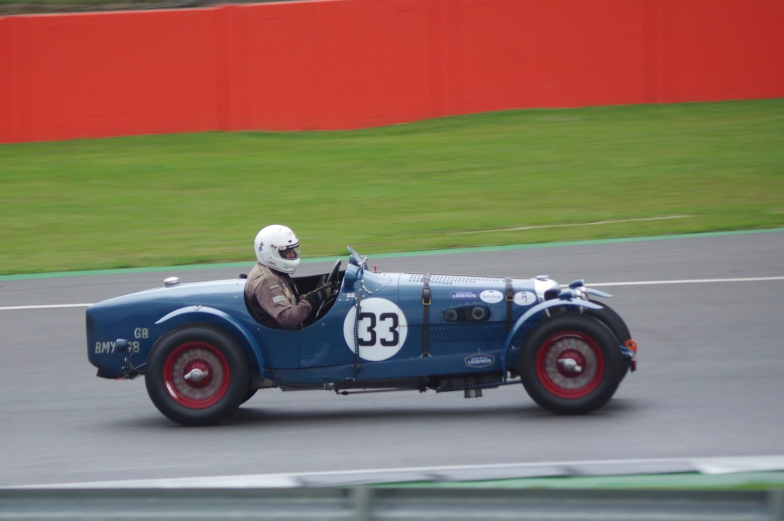 A blue 1934 Riley Kestrel sports special racing on a circuit, numbered 33