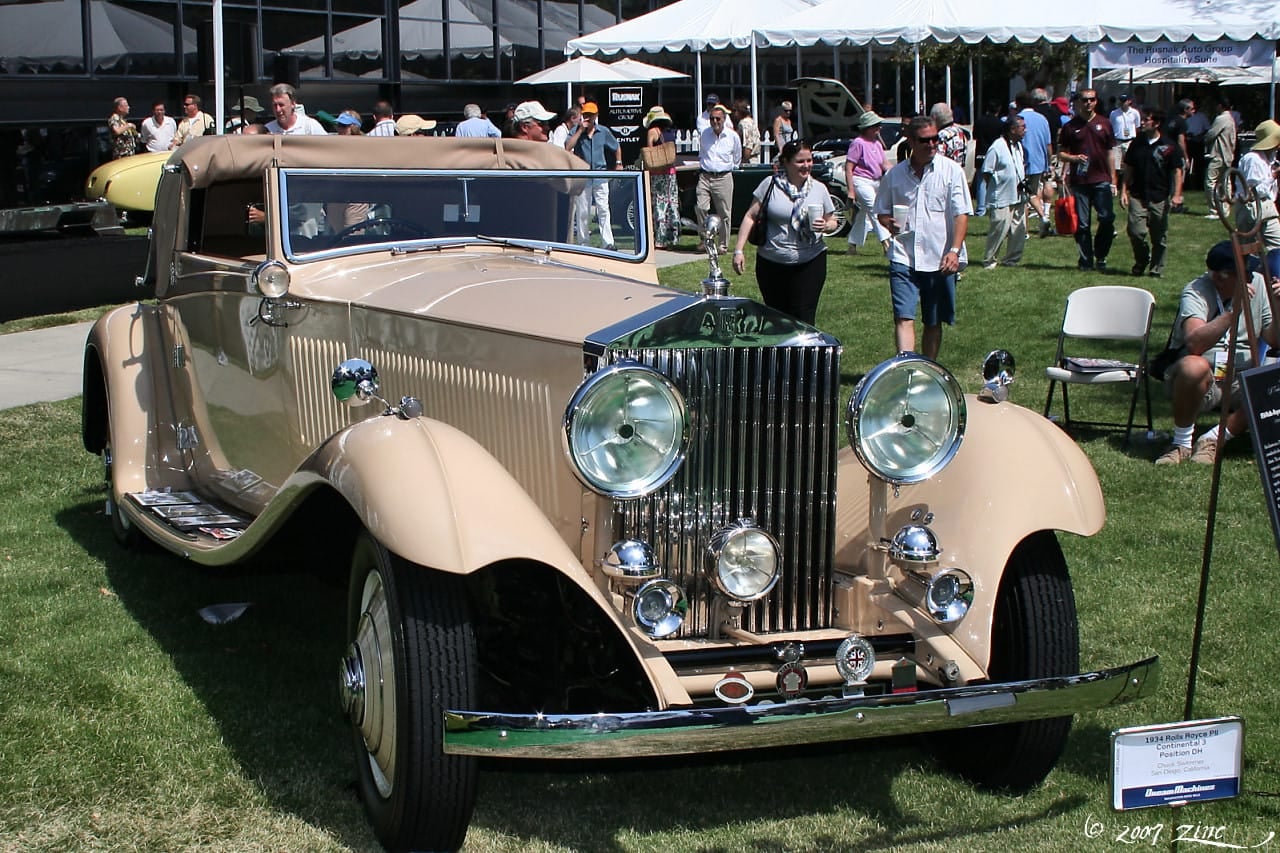 A cream 1934 Rolls-Royce Phantom II Continental, front three-quarter view at a concours