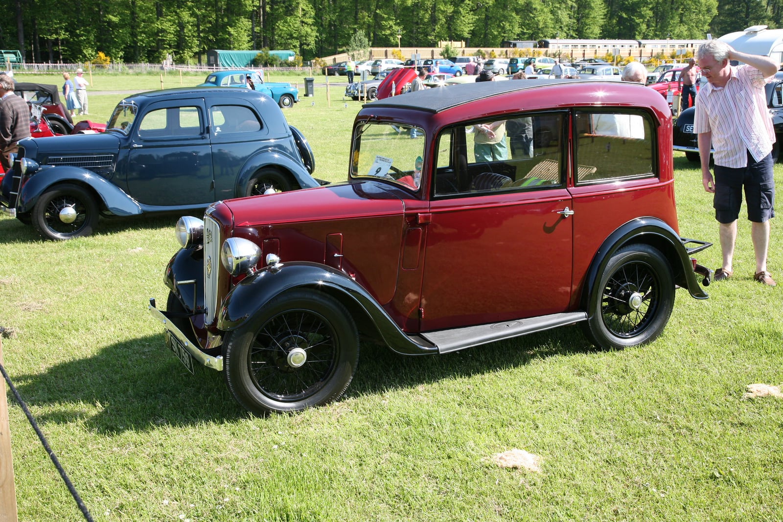 A maroon Austin Seven Ruby saloon of 1935 on grass, front three-quarter view