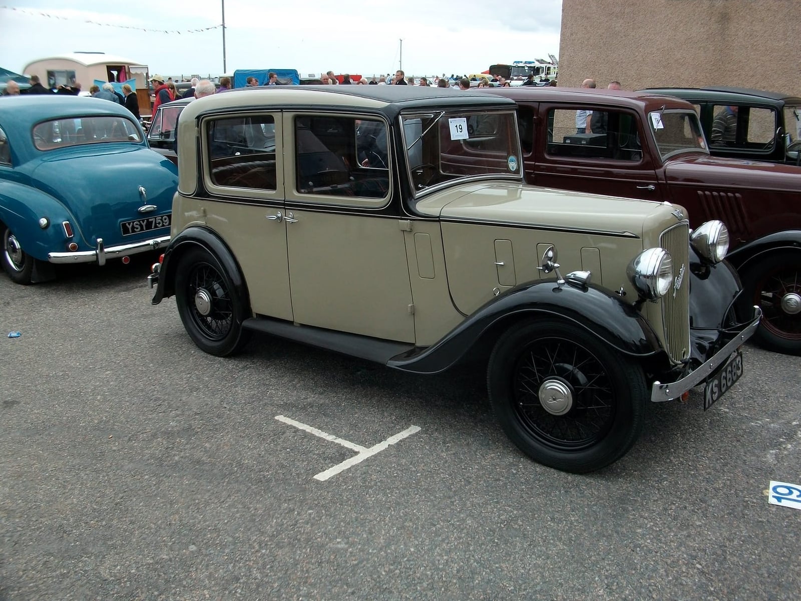 A beige and black 1935 Austin Ten Lichfield saloon in side profile at a classic car show