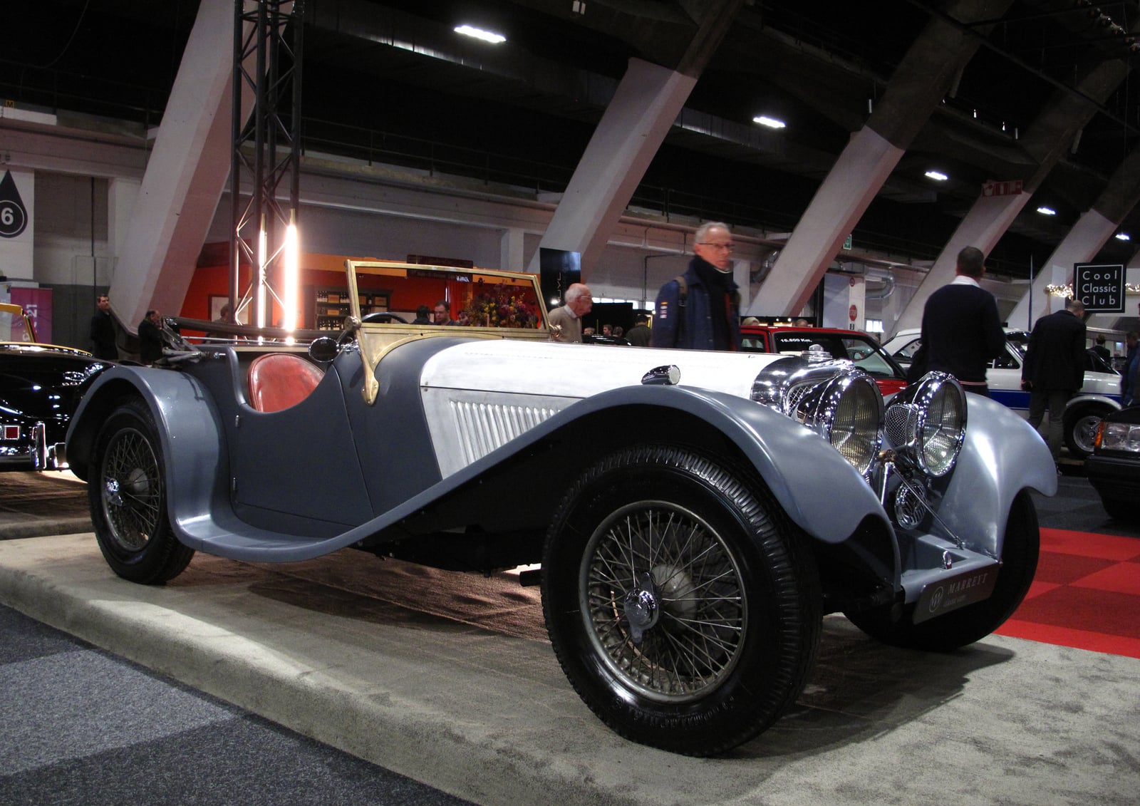 A grey SS Jaguar 100 open sports car at an indoor display