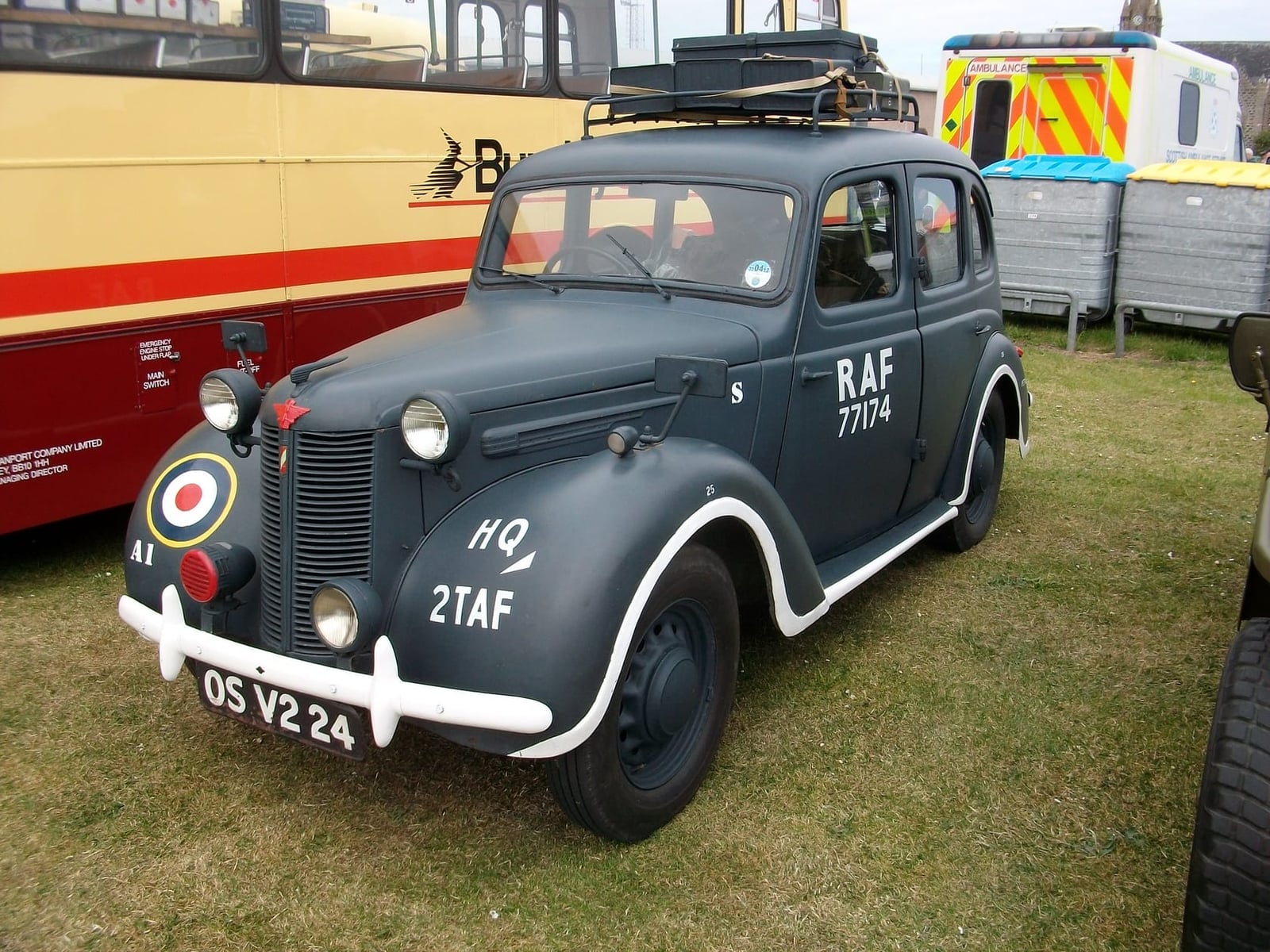 A grey RAF-liveried 1944 Austin Ten staff car with roundel and unit markings at a military vehicle show, UK registration OS V2 24