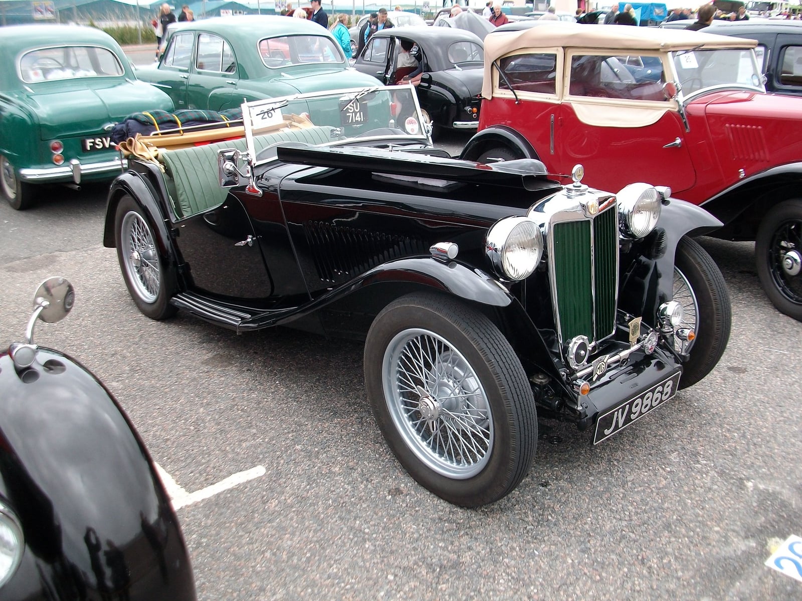 A black MG TC of 1946 on grass, front three-quarter view