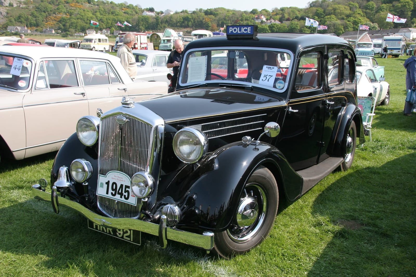 A black 1946 Wolseley 18/85 police car at a vintage transport festival