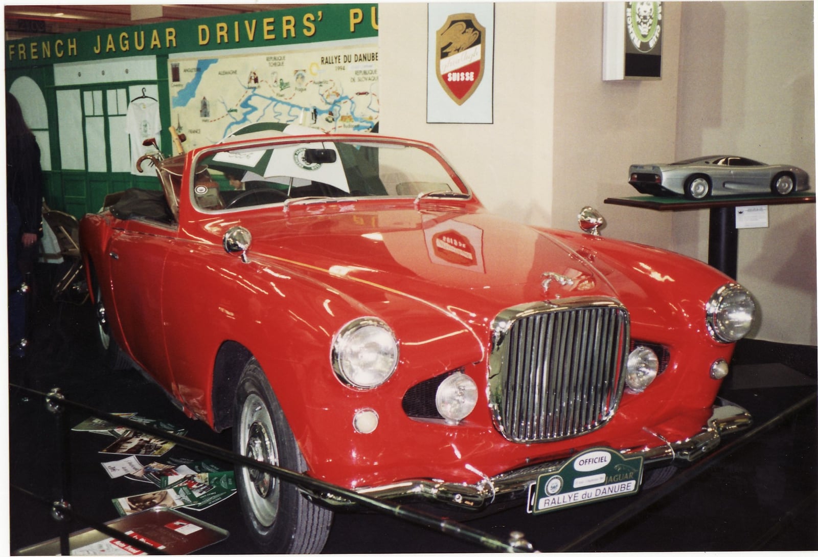 A red Jaguar XK120 with unique coachbuilt bodywork by Ghia Aigle of Switzerland, front three-quarter view