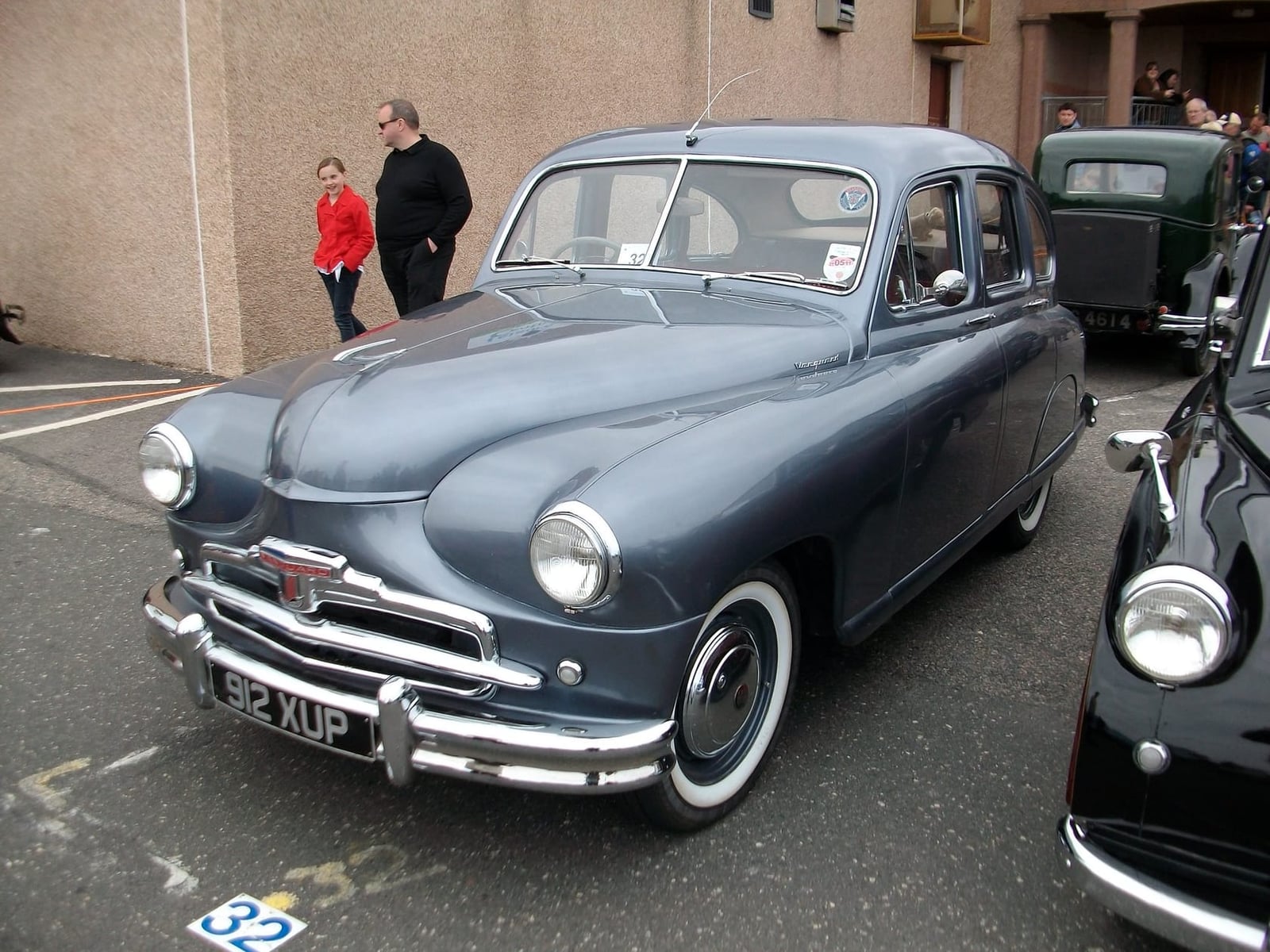 A grey-blue 1952 Standard Vanguard Phase I on a street with onlookers, UK registration 92 XUP