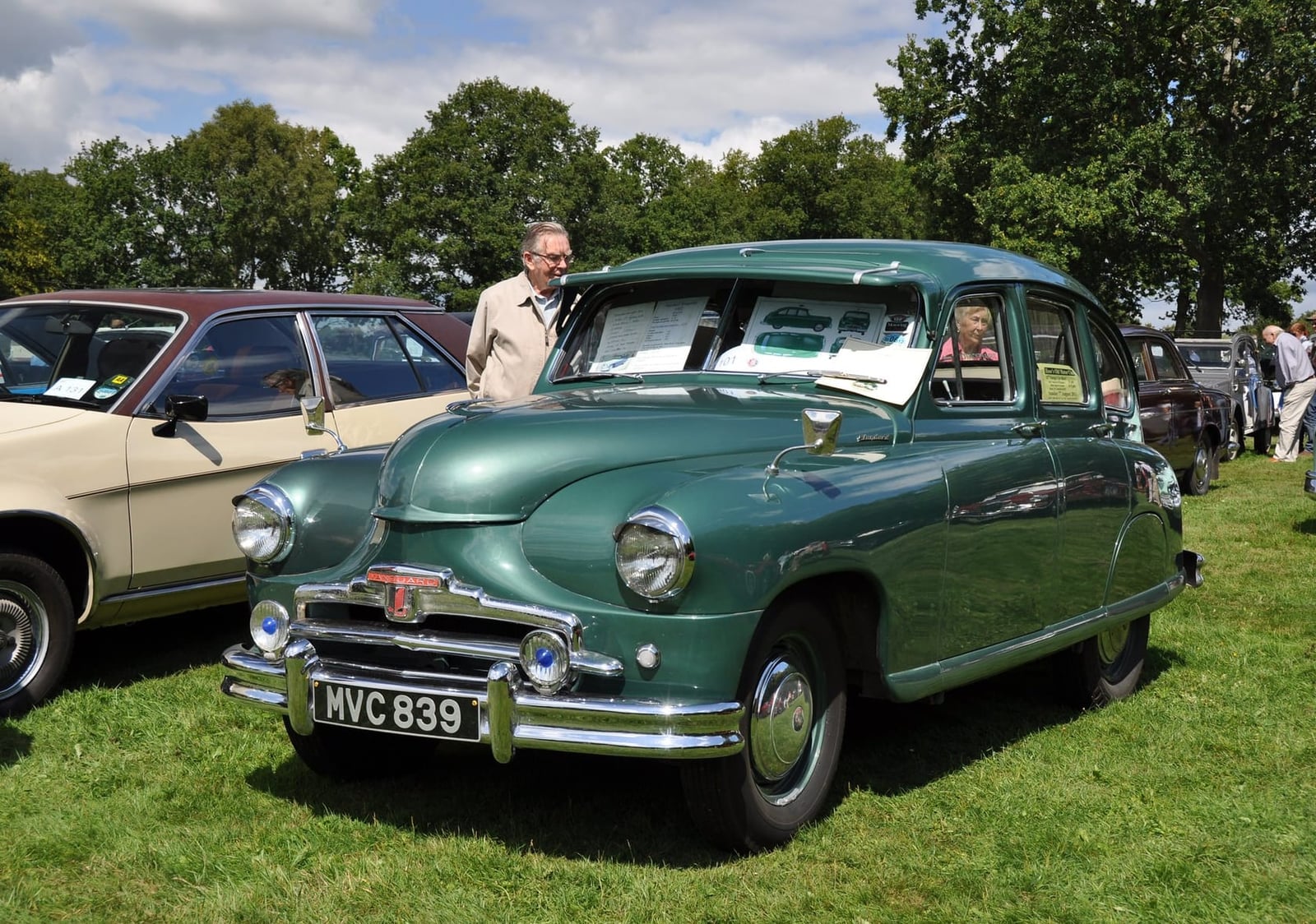 A green Standard Vanguard Phase I on grass at a classic vehicle show, front three-quarter view, UK registration MVC 839