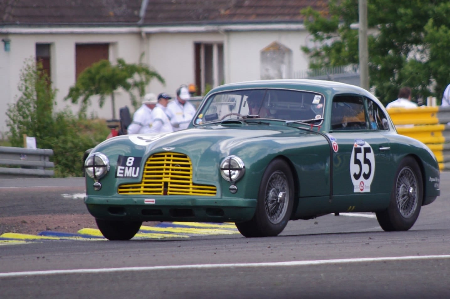 A green 1953 Aston Martin DB2 with racing number 55 at the Le Mans Classic