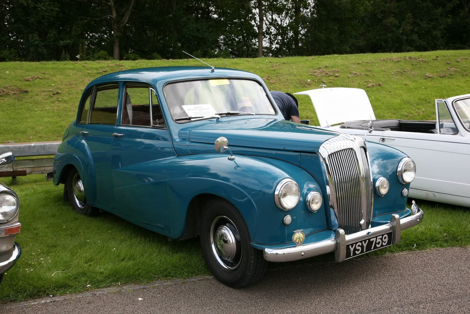 A blue Daimler Conquest saloon on grass at a classic car show, side view, UK registration YSY 759