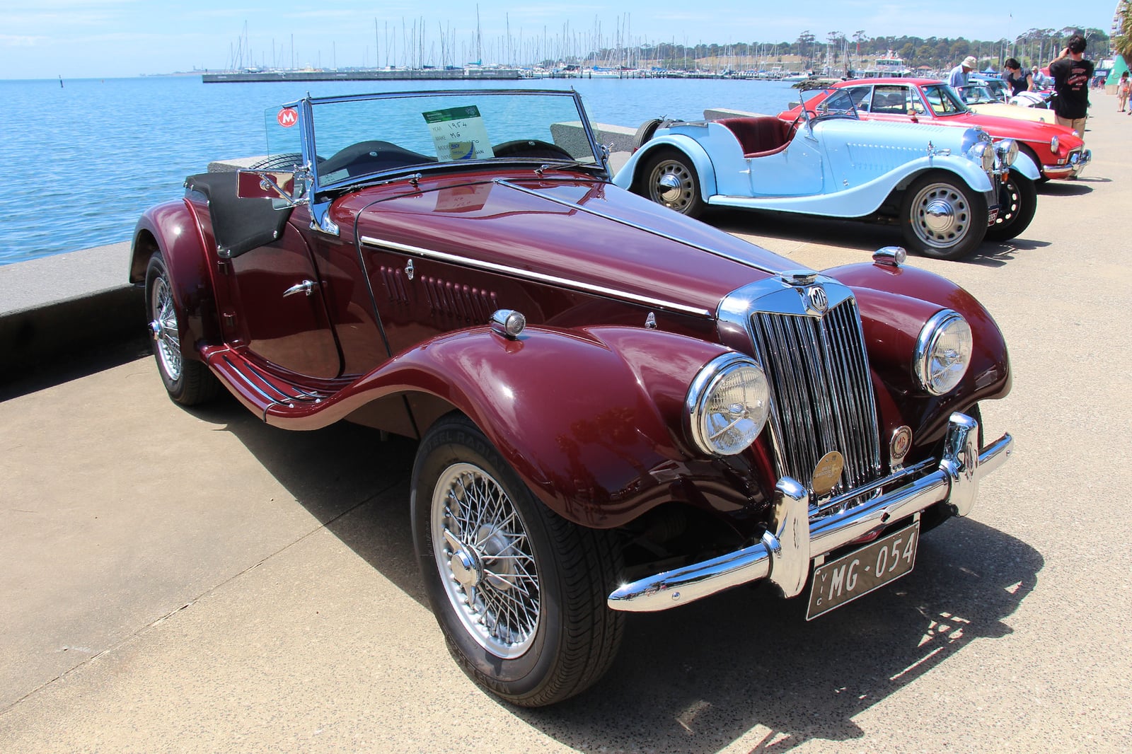 A maroon MG TF roadster of 1953, front three-quarter view