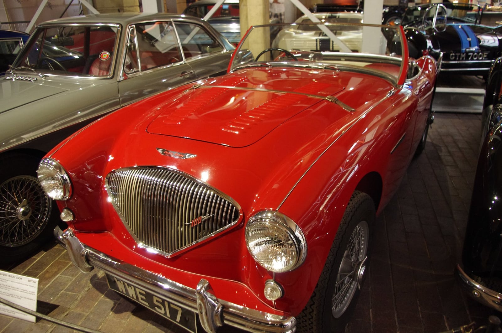 A red Austin-Healey 100M roadster on display