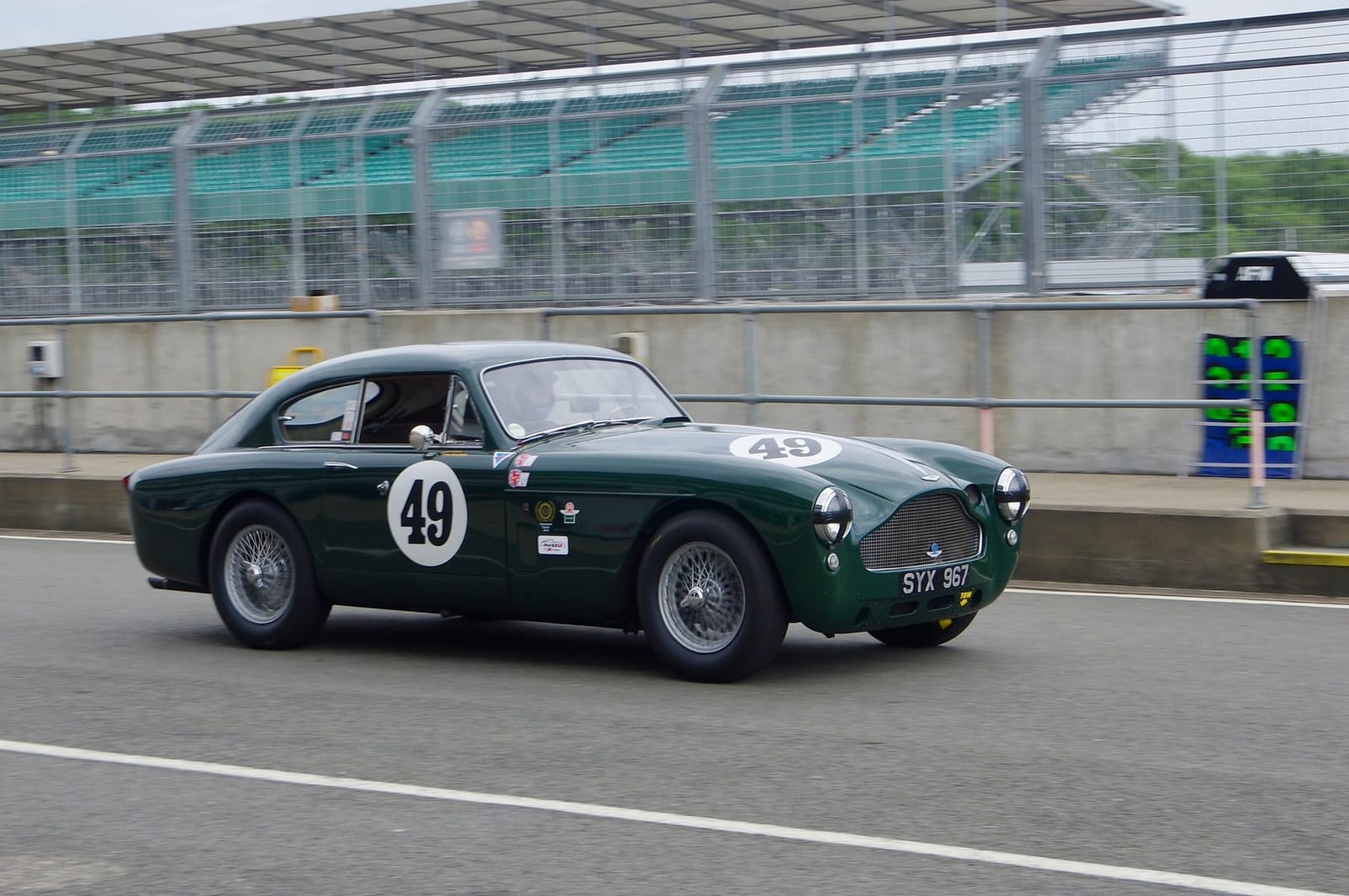 A dark green 1957 Aston Martin DB Mk III, front three-quarter view