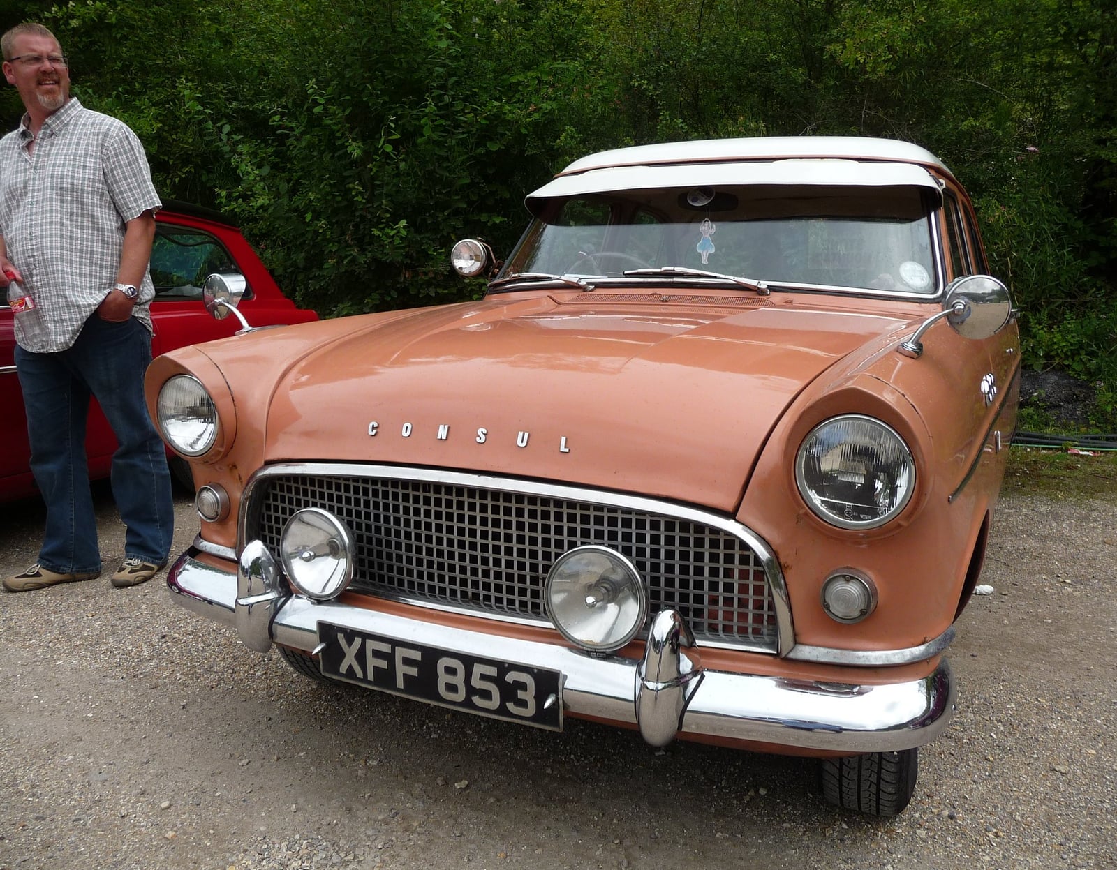 A salmon-and-white Ford Consul Mk2 with a white roof, front view at a show
