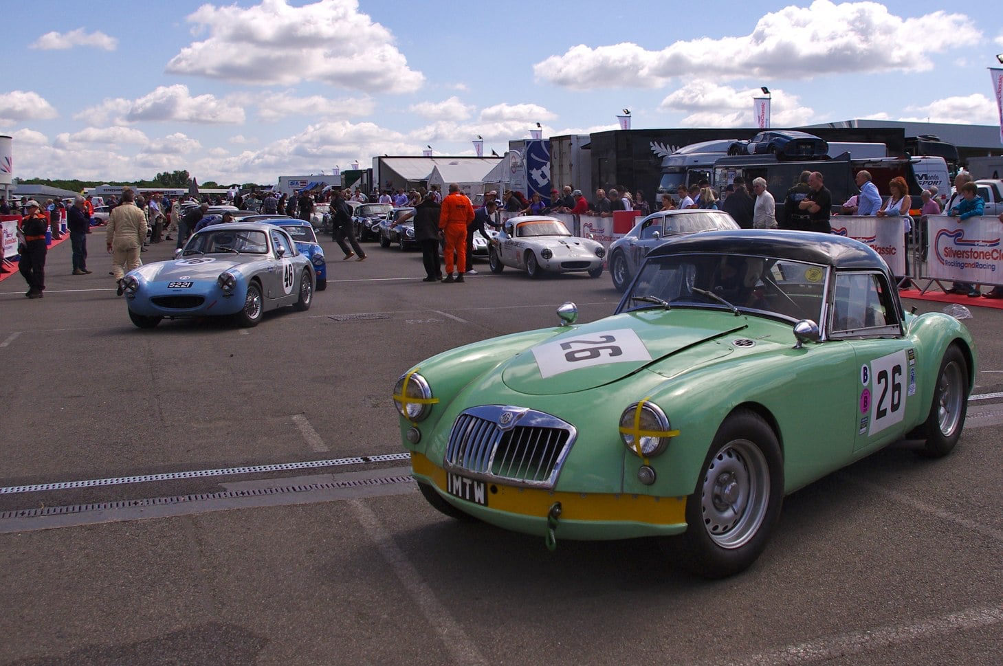 A green MG MGA Twin Cam in a paddock at a historic race meeting