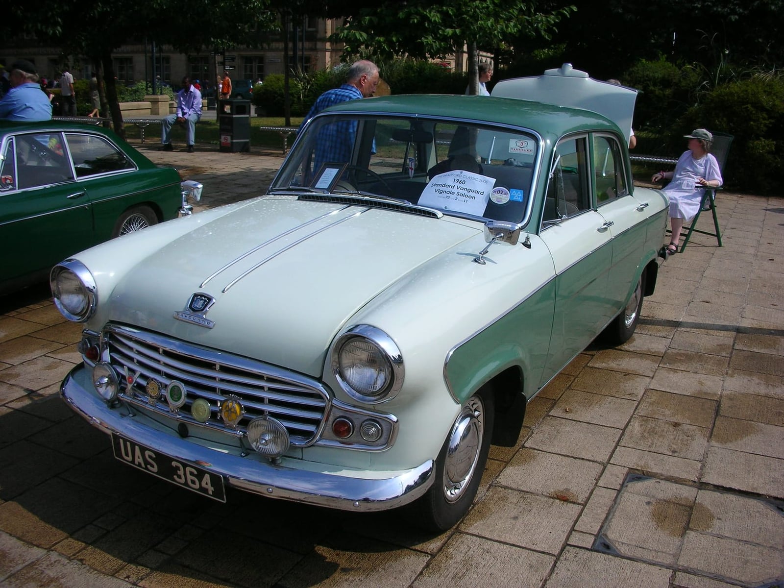 A green and white two-tone 1960 Standard Vanguard Vignale with its bonnet open at a show, UK registration UAS 364
