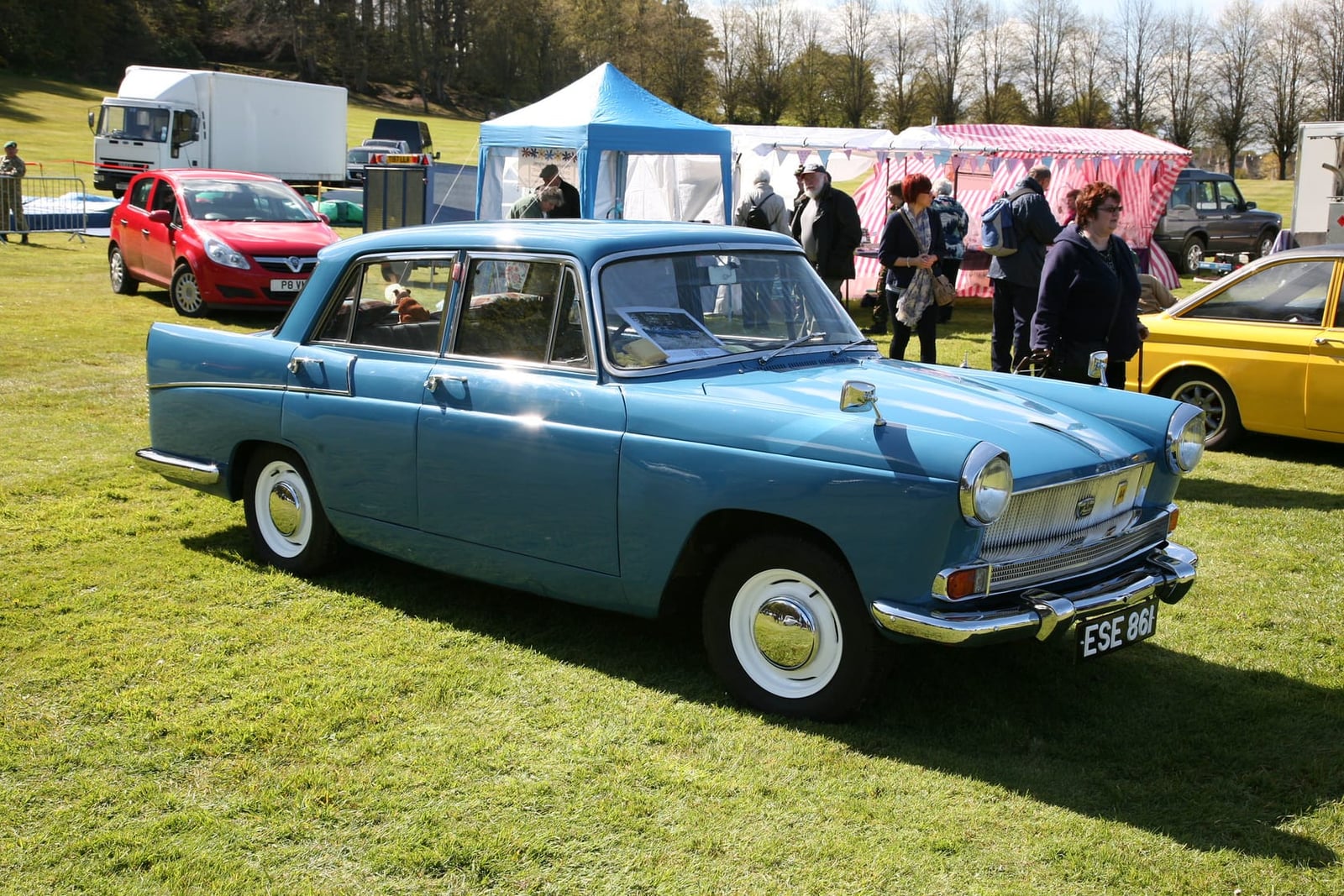 A light blue 1961 Austin A55 Cambridge Mk II with whitewall tyres on a showfield